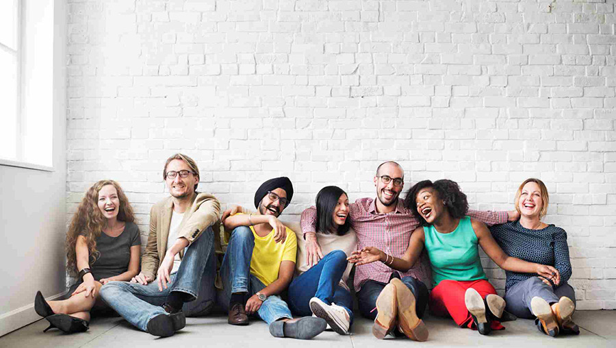多様な人種の人々が、くだけた雰囲気で歓談している様子