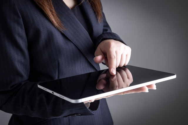 タブレットを操作する女性の手元